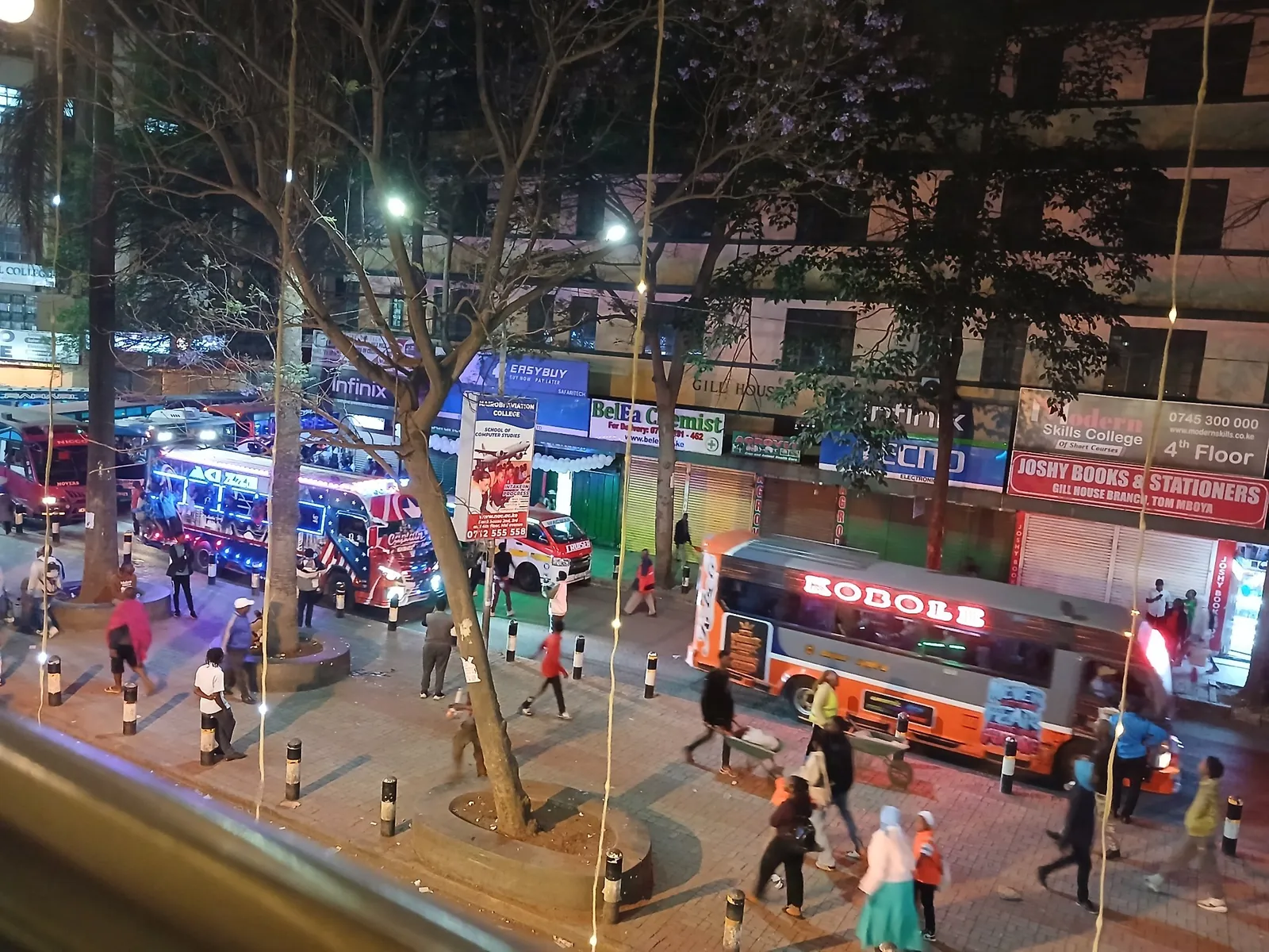 Crowds and lit matatus on Tom Mboya Street during the evening rush in Nairobi
